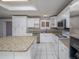 Bright kitchen with white cabinets and granite countertops at 34027 Saint Joe Rd, Dade City, FL 33525