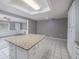 Granite kitchen island with white cabinets and view into living room at 34027 Saint Joe Rd, Dade City, FL 33525