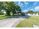 Ranch-style home with carport, mature landscaping, and spacious driveway at 604 Danube Ave, Tampa, FL 33606