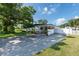 Ranch-style home with carport, mature landscaping, and spacious driveway at 604 Danube Ave, Tampa, FL 33606
