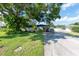Ranch-style home with carport, mature landscaping, and spacious driveway at 604 Danube Ave, Tampa, FL 33606