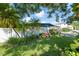Landscaped front yard with lush greenery and a mid-century modern home at 604 Danube Ave, Tampa, FL 33606