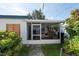 Screened porch with seating area and access to the backyard at 604 Danube Ave, Tampa, FL 33606