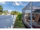 Side yard with a view of the screened porch and fence at 604 Danube Ave, Tampa, FL 33606