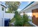 Side yard with a fence and mature plants at 604 Danube Ave, Tampa, FL 33606
