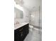 Elegant bathroom with dark vanity, hexagon tile floor, and glass shower at 7516 38Th N Ave, St Petersburg, FL 33710