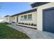 Front walkway and entrance to a remodeled home with a new garage door at 7516 38Th N Ave, St Petersburg, FL 33710