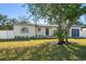 Updated single story home with a large tree and a modern garage at 7516 38Th N Ave, St Petersburg, FL 33710