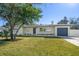 Newly renovated home with a landscaped lawn and modern facade at 7516 38Th N Ave, St Petersburg, FL 33710