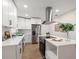 Modern white kitchen with stainless steel appliances and an island at 7516 38Th N Ave, St Petersburg, FL 33710