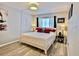 Spacious bedroom with a king-size bed and wood floors at 8651 10Th N St # 130, St Petersburg, FL 33702