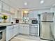 Modern kitchen with white cabinets, granite counters, and stainless steel appliances at 8651 10Th N St # 130, St Petersburg, FL 33702