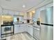 Updated kitchen featuring white cabinets and granite countertops at 8651 10Th N St # 130, St Petersburg, FL 33702