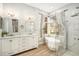 Elegant bathroom featuring a soaking tub, walk-in shower, and double vanity at 8703 Cypress Mill Ct, Tampa, FL 33647