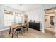 Bright dining area with wood table, black chairs, and modern light fixture at 8703 Cypress Mill Ct, Tampa, FL 33647