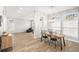 Bright dining room with wooden table and black chairs, adjacent to living room at 8703 Cypress Mill Ct, Tampa, FL 33647