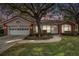 Brick and pink house with a white garage door and landscaped lawn at 8703 Cypress Mill Ct, Tampa, FL 33647
