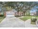 House exterior with a large tree and driveway at 8703 Cypress Mill Ct, Tampa, FL 33647