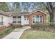 Attractive front entry with brick accents and landscaping at 8703 Cypress Mill Ct, Tampa, FL 33647