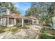 Home exterior showcasing a screened patio and a tranquil backyard at 8703 Cypress Mill Ct, Tampa, FL 33647