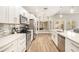 Modern white kitchen with stainless steel appliances at 8703 Cypress Mill Ct, Tampa, FL 33647