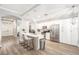 Open kitchen boasts white cabinets and an island at 8703 Cypress Mill Ct, Tampa, FL 33647