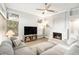 Cozy living room featuring a fireplace and comfortable sectional sofa at 8703 Cypress Mill Ct, Tampa, FL 33647
