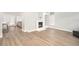 Spacious living area showcasing hardwood floors and a fireplace at 8703 Cypress Mill Ct, Tampa, FL 33647