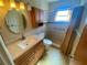 Clean bathroom with a walk-in shower and updated vanity at 889 Sky Loch S Dr, Dunedin, FL 34698