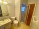 Bathroom with toilet, sink, and shower at 889 Sky Loch S Dr, Dunedin, FL 34698