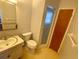 Bathroom with toilet, sink, and shower at 889 Sky Loch S Dr, Dunedin, FL 34698