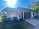 Front view of a single-story house with carport at 889 Sky Loch S Dr, Dunedin, FL 34698