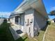 Rear view of a single-story house with a back door at 889 Sky Loch S Dr, Dunedin, FL 34698