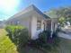 Side view of a single-story house with a green roof at 889 Sky Loch S Dr, Dunedin, FL 34698