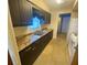 Kitchen with dark brown cabinets and granite countertop at 889 Sky Loch S Dr, Dunedin, FL 34698