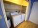 Neat laundry closet with washer and dryer hook ups at 889 Sky Loch S Dr, Dunedin, FL 34698