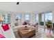 Living room features a comfy couch and a large window at 100 Beach Ne Dr # 1501, St Petersburg, FL 33701