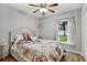 Bright bedroom with floral bedding and a window overlooking the backyard at 10618 Foxcrest Way, Riverview, FL 33569