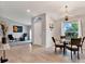 Dining area with glass table, four chairs and a chandelier at 10618 Foxcrest Way, Riverview, FL 33569