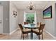 Round glass dining table with four chairs, hardwood floor and natural light at 10618 Foxcrest Way, Riverview, FL 33569