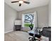 Home office features a glass desk, window, and neutral wall colors at 10618 Foxcrest Way, Riverview, FL 33569