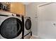 Laundry room with Samsung washer and dryer, plus wooden cabinets at 10618 Foxcrest Way, Riverview, FL 33569
