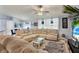 Spacious living room with sectional sofa, large TV and ceiling fan at 10618 Foxcrest Way, Riverview, FL 33569