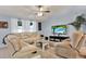 Relaxing living room with sectional sofa, large TV and ceiling fan at 10618 Foxcrest Way, Riverview, FL 33569