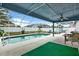 Relaxing screened pool area with patio furniture and lush green grass at 10618 Foxcrest Way, Riverview, FL 33569