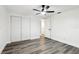 Bedroom with gray vinyl flooring, double doors, and neutral walls at 11592 110Th Ter, Seminole, FL 33778