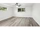 Spacious bedroom with ceiling fan and gray vinyl flooring at 11592 110Th Ter, Seminole, FL 33778