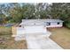 Newly renovated home with gray exterior and landscaping at 11592 110Th Ter, Seminole, FL 33778