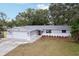 Newly renovated home with gray exterior and landscaping at 11592 110Th Ter, Seminole, FL 33778