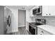 Bright kitchen, stainless steel appliances and white cabinets at 11592 110Th Ter, Seminole, FL 33778
